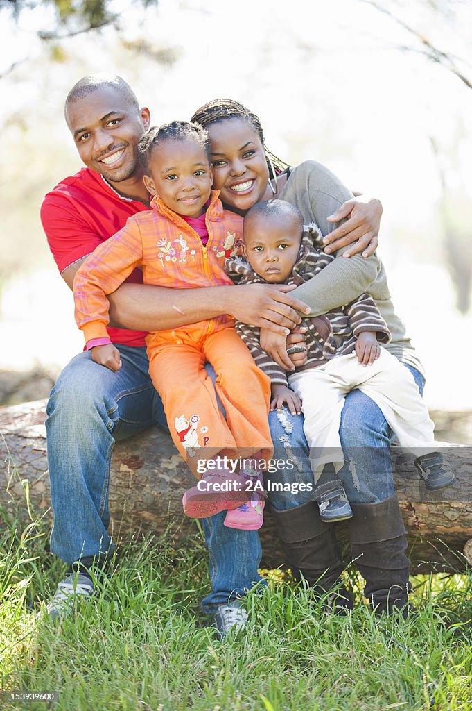 Family of four hugging and smiling, Johannesburg, South Africa