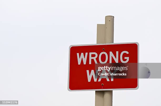 wrong way sign post - wrong direction stock pictures, royalty-free photos & images