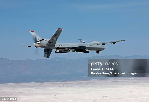 an mq-9 reaper flies a training mission over the white sands national monument in southern new mexico. - weapon stock pictures, royalty-free photos & images