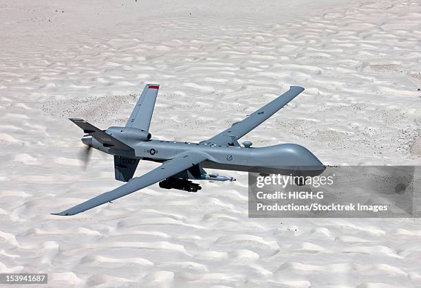 an mq-9 reaper flies a training mission over the white sands national monument in southern new mexico. - weapon stock pictures, royalty-free photos & images