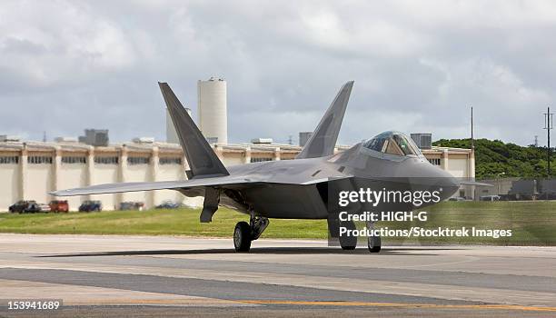 an f-22 from langley air force base, virginia, taxi's to the end of runway for pre-flights before taking off on a training mission at kadena air base, okinawa - langley air force base stock pictures, royalty-free photos & images