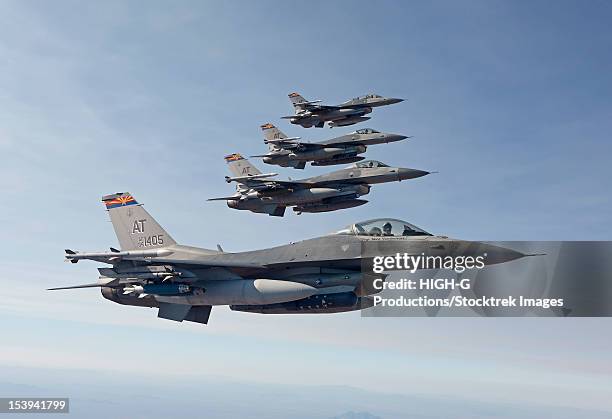 four f-16's from the air national guard air force reserve test center fly in formation during a test mission out of the tucson international airport, arizona. - air force reserve stock-fotos und bilder