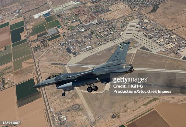 an f-16 fighting falcon from the 56th fighter wing at luke air force base, arizona, performs an sfo during a training mission. - military base stock pictures, royalty-free photos & images