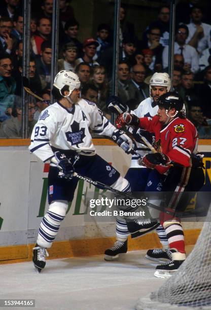 Jeremy Roenick of the Chicago Blackhawks checks Doug Gilmour of the Toronto Maple Leafs during their game on April 12, 1994 at the Maple Leaf Gardens...