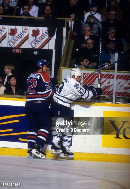 Doug Gilmour of the Toronto Maple Leafs checks Luke Richardson of the Edmonton Oilers during their game on April 13, 1996 at the Maple Leaf Gardens...