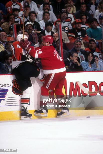 Brendan Shanahan of the Detroit Red Wings checks Janne Niinimaa of the Philadelphia Flyers into the boards during the 1997 Stanley Cup Finals in...