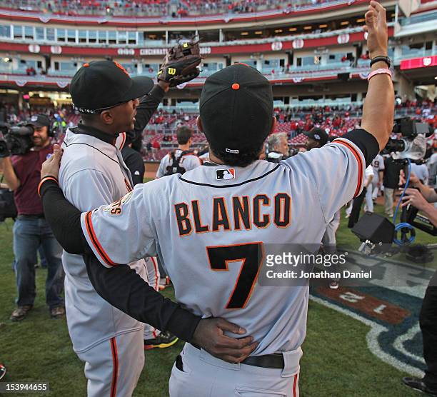 Joaquin Arias and Gregor Blanco of the San Francisco Giants celebrate a win against the Cincinnati Reds in Game Five of the National League Division...