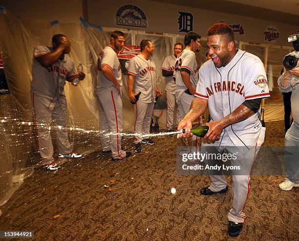 Pablo Sandoval of the San Francisco Giants celebrates in the locker room following Game Five of the National League Division Series against the...