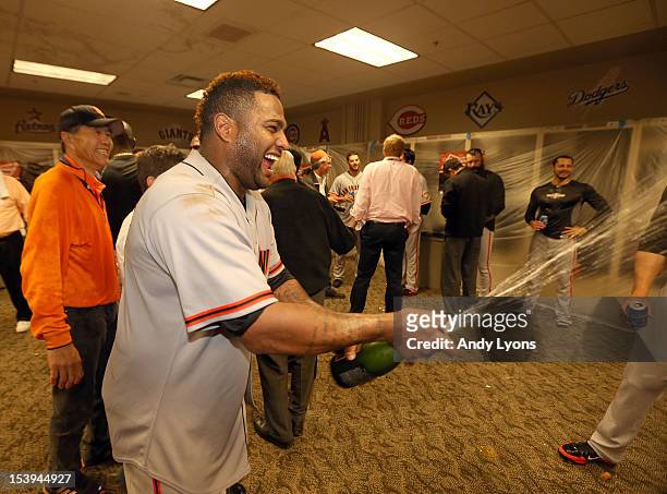 Pablo Sandoval of the San Francisco Giants celebrates in the locker room following Game Five of the National League Division Series against the...