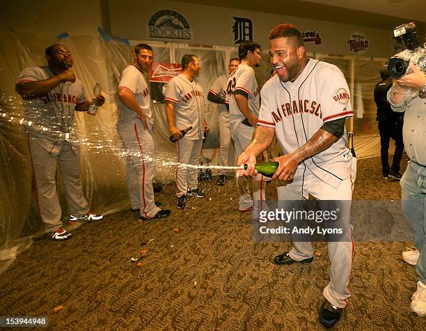 Pablo Sandoval of the San Francisco Giants celebrates in the locker room following Game Five of the National League Division Series against the...