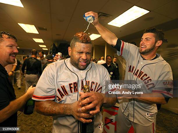 Pablo Sandoval of the San Francisco Giants has beer poured on him by George Kontos as he celebrates in the locker room following Game Five of the...
