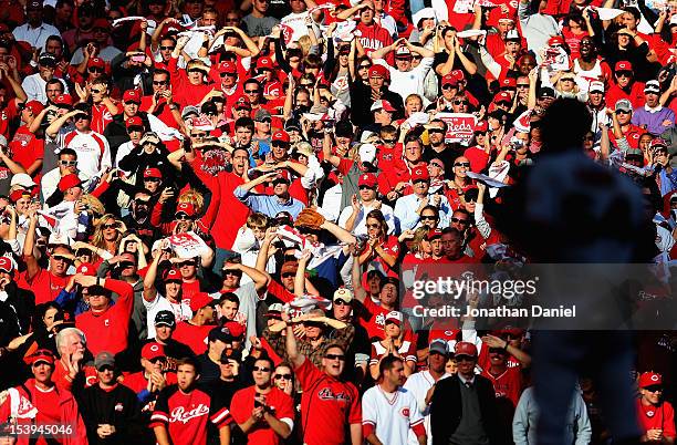 Fans of the Cincinnati Reds cheer in the 9th inning as Sergio Romo of the San Francisco Giants waits to pitch in Game Five of the National League...