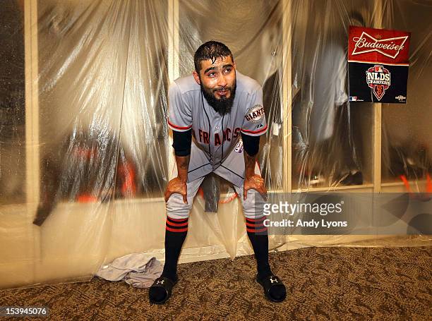 Sergio Romo of the San Francisco Giants celebrates in the locker room following Game Five of the National League Division Series against the...