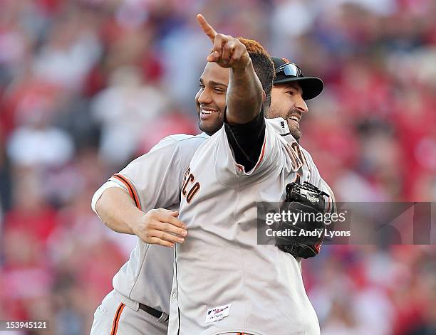 Pablo Sandoval of the San Francisco Giants celebrates with Xavier Nady following the last out og Game Five of the National League Division Series...