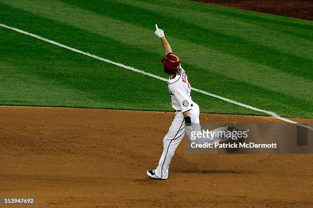 Jayson Werth of the Washington Nationals celebrates as he rounds first base on his solo game-winning walk-off home run in the bottom of the ninth...
