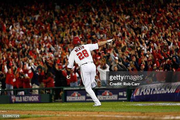 Jayson Werth of the Washington Nationals celebrates as he run to first base on his solo game-winning walk-off home run in the bottom of the ninth...