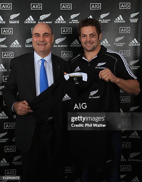 All Black captain Richie McCaw and AIG Executive Vice President Peter Hancock pose with the All Black jersey during a NZRU and AIG sponsorship...