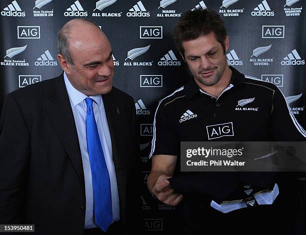 All Black captain Richie McCaw and AIG Executive Vice President Peter Hancock look at the new All Black jersey during a NZRU and AIG sponsorship...