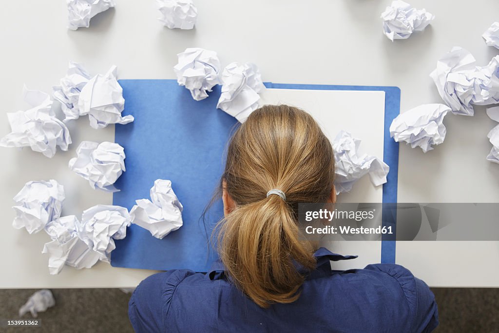 Germany, Businesswoman with file on table