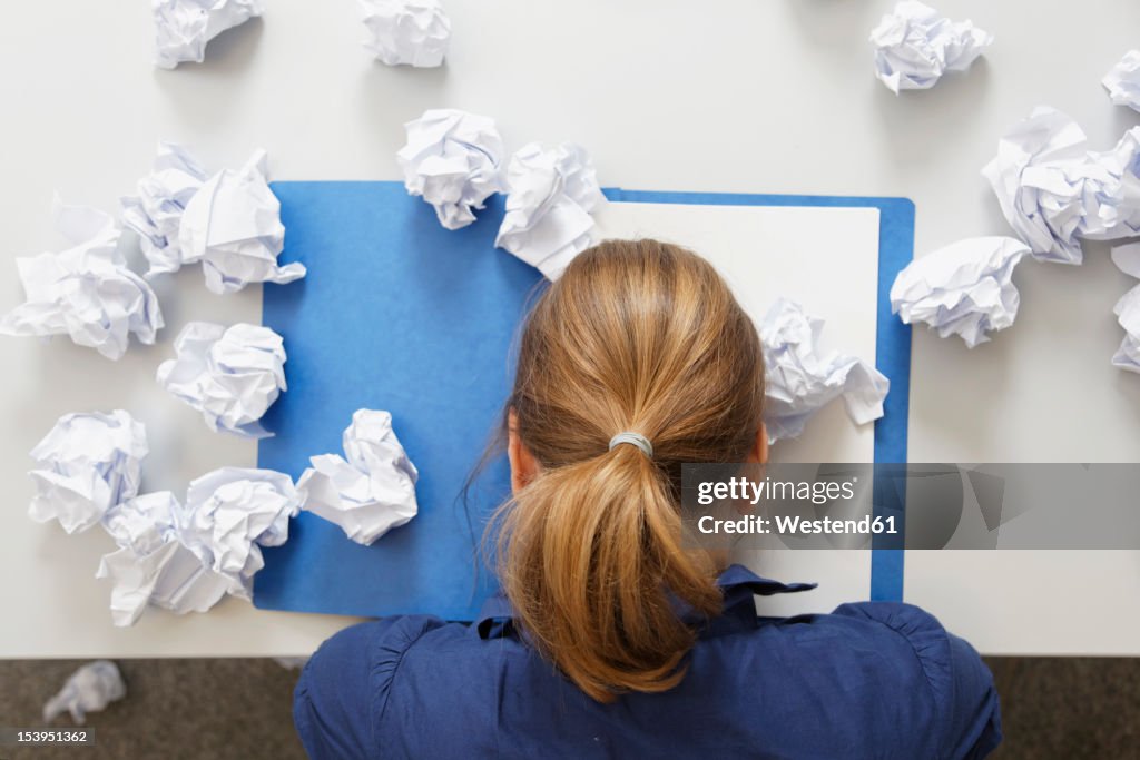 Germany, Businesswoman with file on table