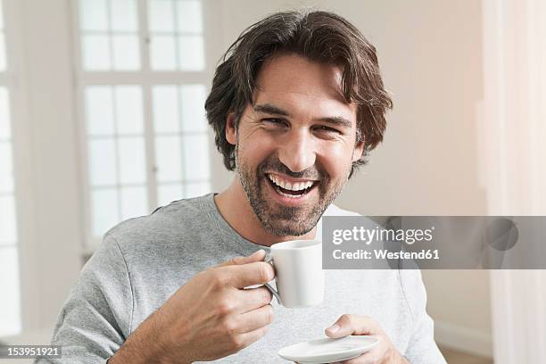germany, berlin, mature man with coffee cup, smiling, portrait - facial hair stock pictures, royalty-free photos & images