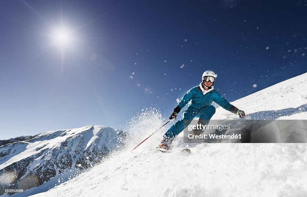 Austria, Salzburg, Young man skiing on mountain