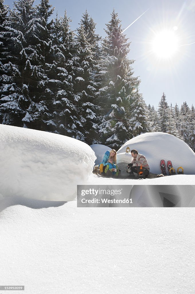 Austria, Salzburg County, Couple sitting near igloo