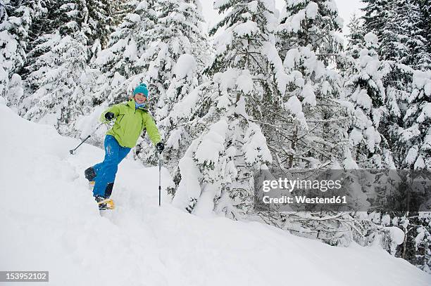 austria, salzburg county, young woman snowshoeing - schneeschuhwandern stock-fotos und bilder