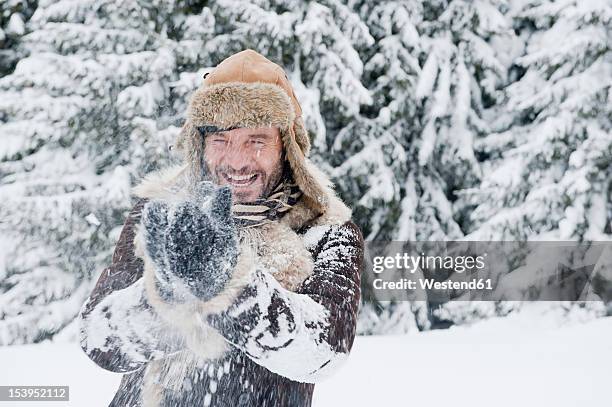 austria, salzburg county, mature man having fun in snow, smiling - salzburg winter foto e immagini stock