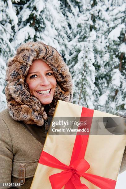 Austria Salzburg County Mid Adult Woman Standing With Christmas Parcel Smiling Portrait High-Res Stock Photo
