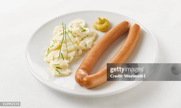 pair of sausages with potato salad and mustard in plate on white background - potato salad stock pictures, royalty-free photos & images