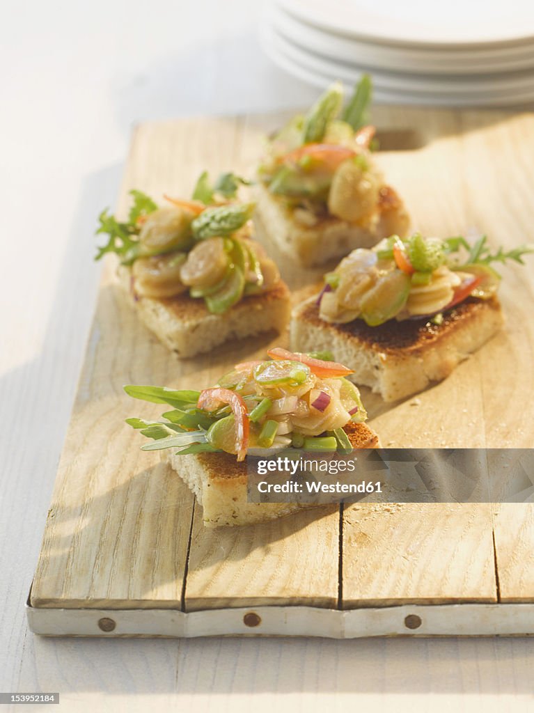 Asparagus bruschetta on wood board