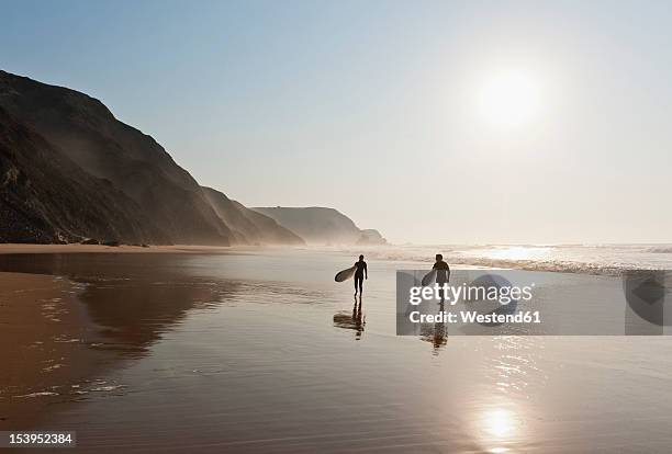 portugal, couple walking with surfboard on beach - portugal coast stock pictures, royalty-free photos & images