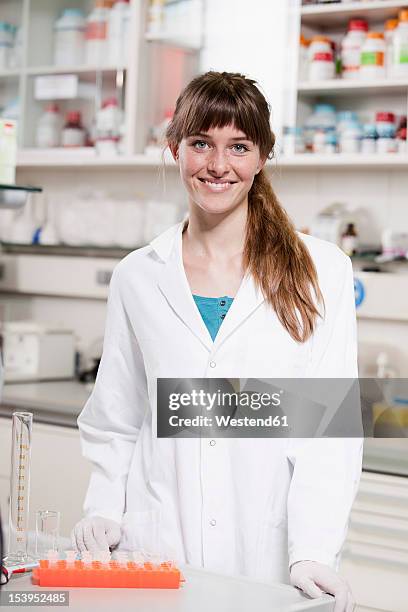 germany, bavaria, munich, scientist with test tubes in laboratory - scientist standing next to table stock pictures, royalty-free photos & images