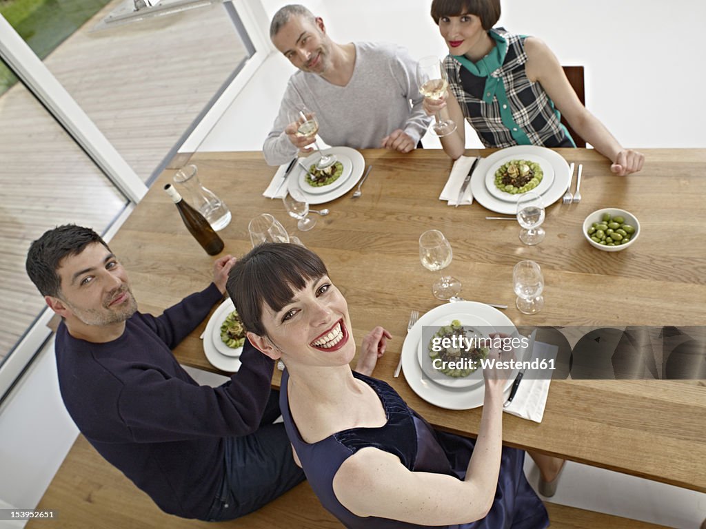 Germany, Cologne, Men and women having dinner
