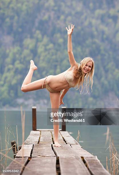 austria, teenage girl standing on jetty, portrait - teen girl barefoot stock pictures, royalty-free photos & images