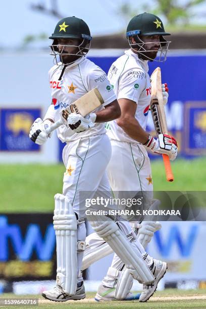 Pakistan's Agha Salman and Saud Shakeel run between the wickets during the third day play of the first cricket Test match between Sri Lanka and...