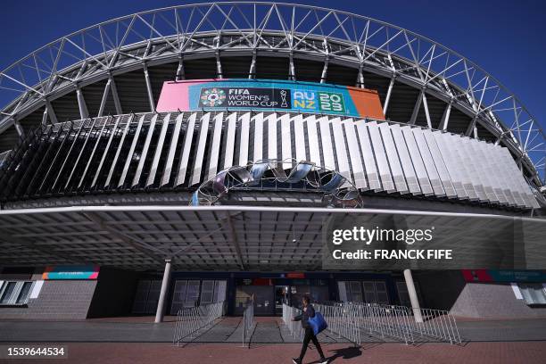 Man looks up at a promotional display for the Women's World Cup football tournament as he walks past Stadium Australia, also known as Olympic...