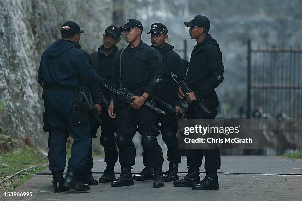 Indonesian police forces prepare to take up positions prior to the start of the Bali Bombing 10th anniversary ceremony held at Garuda Wisnu Kencana...