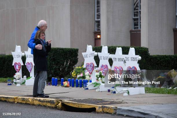 Mourners gather at a memorial in front of the Tree of Life Synagogue on Monday, October 29, 2018 where 11 people were killed in a mass shooting on...