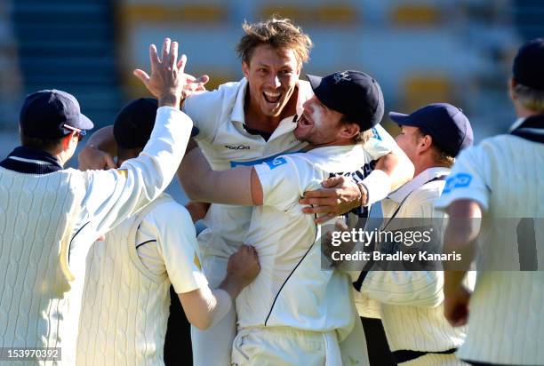 James Pattinson of the Bushrangers celebrates after taking his fifth wicket of the innings during the Sheffield Shield match between the Queensland...