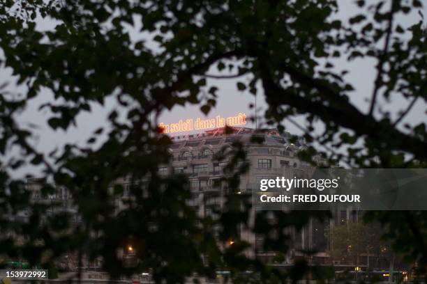 Picture taken on October 11, 2012 shows the artwork installation "Du soleil dans la nuit" by French artist Laurent Grasso, a 25metre-neon light set...