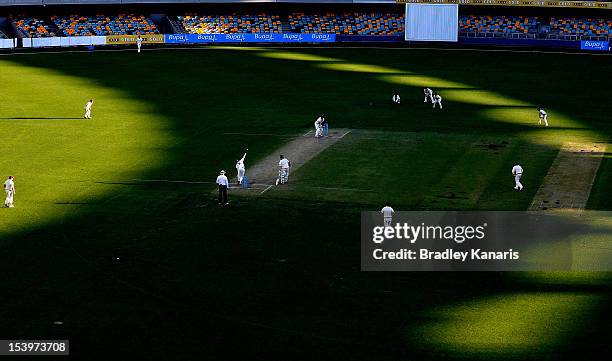 Alister McDermott of the Bulls bowls to Chris Rogers of the Bushrangers during the Sheffield Shield match between the Queensland Bulls and the...