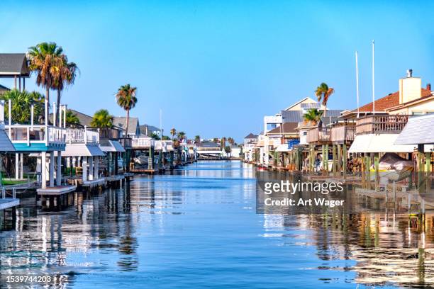 galveston homes on the canal - flood plain stock pictures, royalty-free photos & images