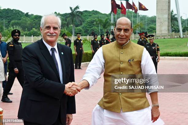 Argentine Defence Minister Jorge Taiana shakes hands with his Indian counterpart Rajnath Singh before inspecting a guard of honour at the Manekshaw...