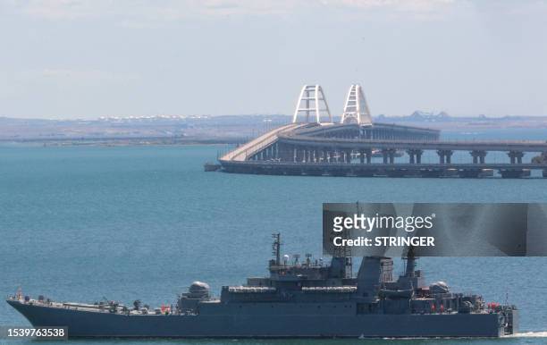 Picture taken on July 17, 2023 shows a Russian warship sailing near the Kerch bridge, linking the Russian mainland to Crimea, following an attack...