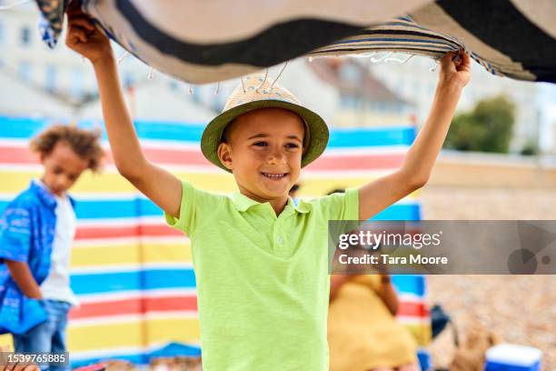 boy with beach towel - beach towel stock pictures, royalty-free photos & images