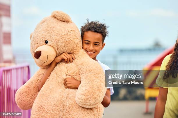 boy with teddy prize - stuffed toy stock pictures, royalty-free photos & images