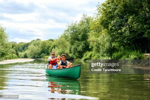 family canoe adventure - kids kayaking in river stock pictures, royalty-free photos & images