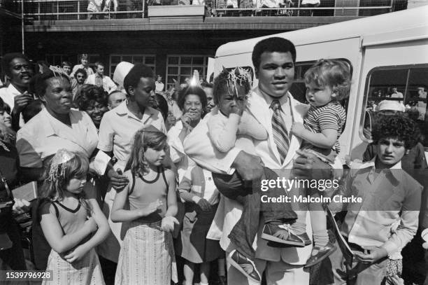 Heavyweight boxer Muhammad Ali poses with children during a visit to Great Ormond Street Hospital in London, August 11th 1977.